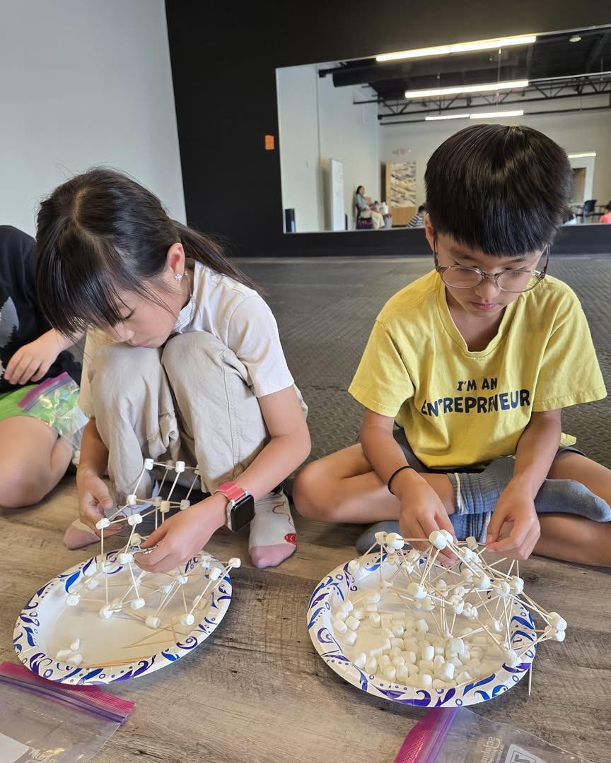 Two Arrow Academy students building with marshmallows